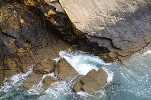 Rock textures and waves in a cliff in Galicia, Spain Stock Photos