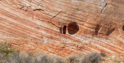 A rock wall with a hole in it Stock Photos