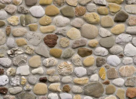 Rock wall of natural an rounded river stones Stock Photos