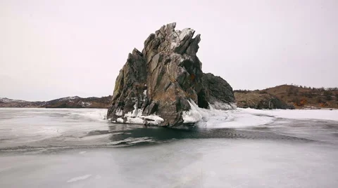 A rock in the water with ice Stock Footage 49089191