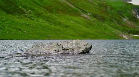Rock in water of mountain lake 스톡 동영상 65764366