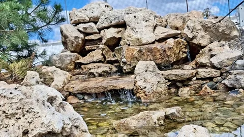 Rock Waterfall Feature with Cascading Stream in Garden Stock Footage 335505140