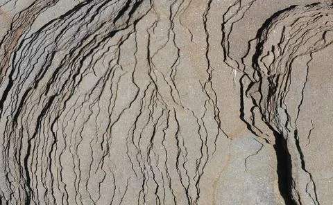 A rock with wave like striations. Foto stock