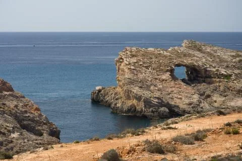 Rock window in Comino, which is the third biggest island of Malta. Stock Photos