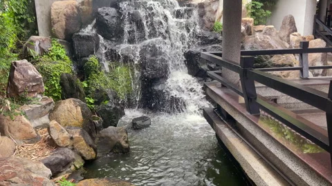 Rockery Waterfall And Stepped Pool Beside A Shaded Walkway Stock Footage 344241731