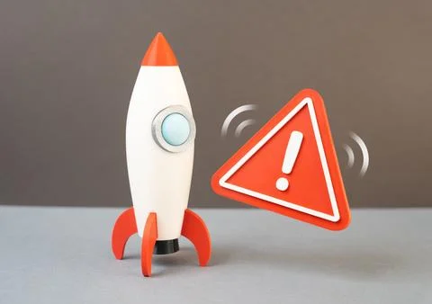 A rocket and a danger sign symbolizing a failed startup and technological set Stock Photos