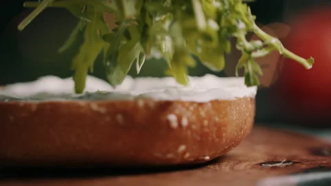 Rocket Being Placed On Hamburger Bun With Greek Dressing Video stock 134401953