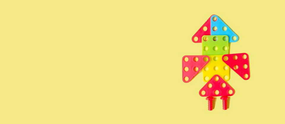 Rocket from a children's constructor on a yellow background Stock Photos