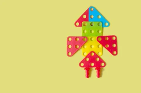 Rocket from a children's constructor on a yellow background Stock Photos