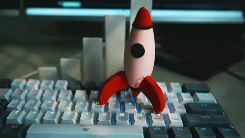 Rocket on Computer Keyboard Symbolizing Innovation Footage, A small rocket .. Stock Footage 304961813