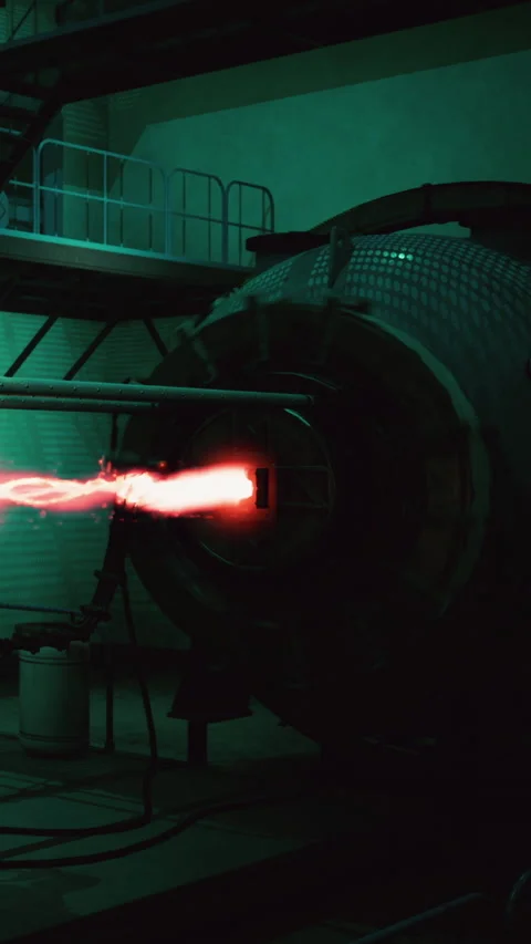 Rocket engine test occurs in a dark industrial setting with bright flames Stock Footage 337951662