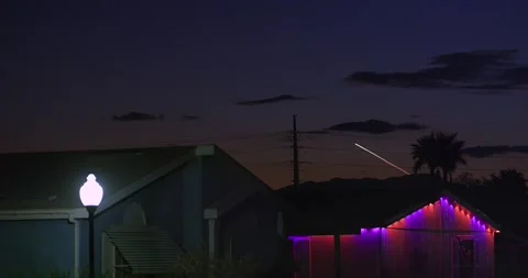 Rocket launch over a nondescript desert neighborhood community at twilight. Stock Footage 318199068