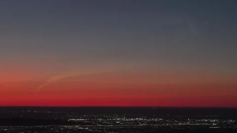 Rocket launch trail in red sunset sky over city Stock Footage 346301045