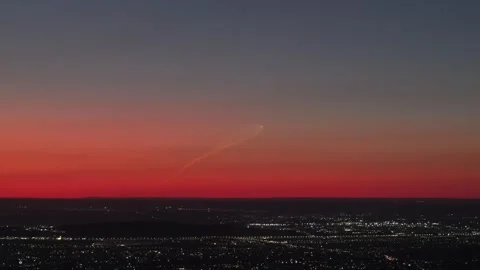 Rocket launch trail in red sunset sky over city Stock Footage 346301109