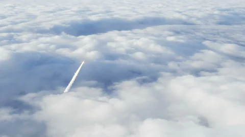 Rocket penetrating through the clouds leaving trail of smoke in its wake Vídeo Stock 68311518