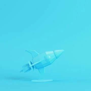 Rocket with stand on bright blue background in pastel colors. Minimalism conc Illustrazione stock