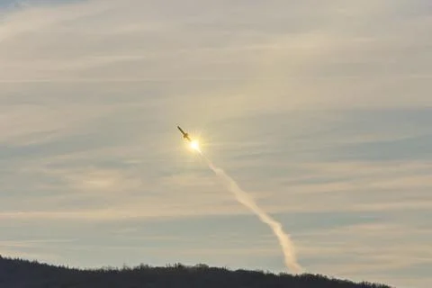 The rocket takes off into the sky behind clouds, gas jets from a jet engine.Conc Fotos de archivo