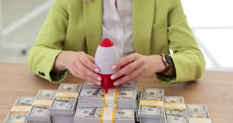 Rocket taking off from stack of money dollar bills closeup 4k movie slow motion Stock Footage 260340109