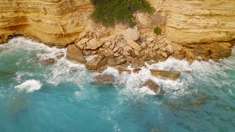 Rockfall and sea foam seen on a remote rocky coast of Kefalonia from above Stock Footage 312177553