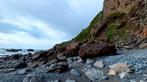 Rockfall on beach collapsed cliffs due to winter storms and high seas Waterford Stock Footage 331355059