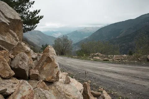 Rockfall on the road in the mountains. Stock Photos