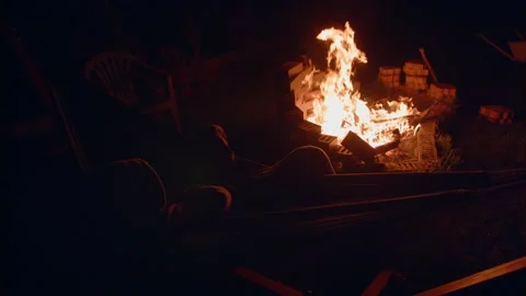 Rocking on a hammock in the background, a bonfire Stock Footage 152527913