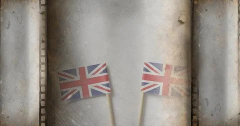 Rocking two Union Jack flags in studio filmstrip sprocket backdrop, with 写真素材