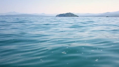Rocking view of ocean surface with islands on the horizon. Stock-Footage 74503612