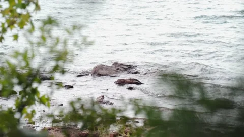 Rocks alone in a lake 스톡 동영상 228655595