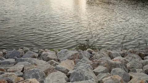 Rocks along the lake Stockbeeldmateriaal 124815350