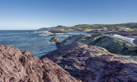 Rocks and a Distant View of the community of Tickle Cove, Canada Stock Photos