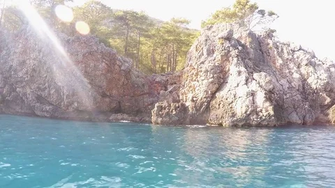 Rocks and forest view from a boat on the waves of the Mediterranean Sea Stock Footage 81746245