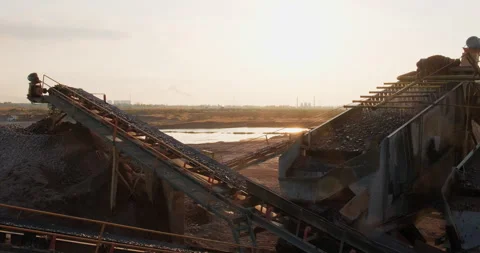 Rocks and sand move on conveyor lines, move through vibrating screen. Screening Stock Footage 292976904