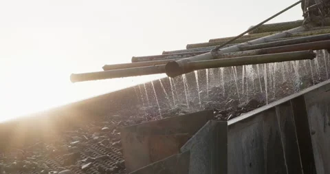 Rocks and sand move through vibrating screen. Crushing screening plant Stock Footage 289672229
