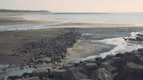 Rocks and stone tetrapod blocks on the beach Stock Footage 64116162