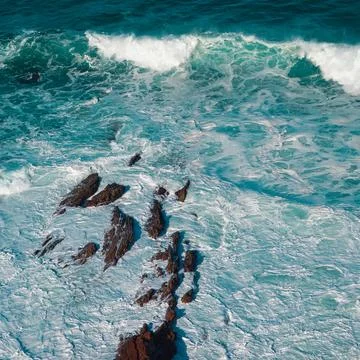 Rocks and waves on the coast Stock Photos