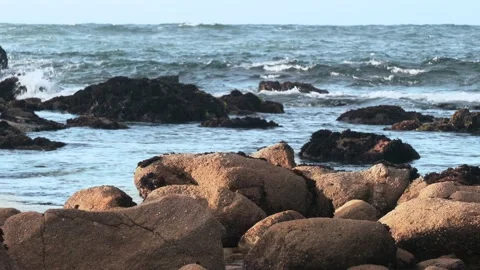 Rocks and Waves flowing in. Stock Footage 186803538
