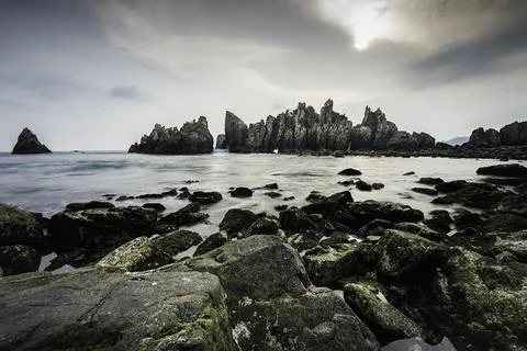 Rocks and waves in the sea. Stock Photos