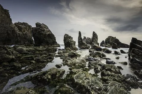 Rocks and waves in the sea. Stock Photos