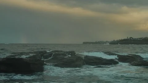 Rocks and waves at sunset with rainbow in Sydney with sound 4K Video stock 276063329