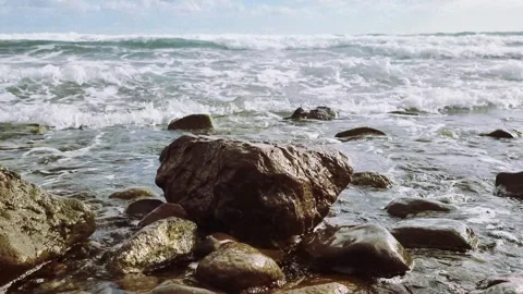 Rocks are battered by the sea waves Stock Footage 332794396