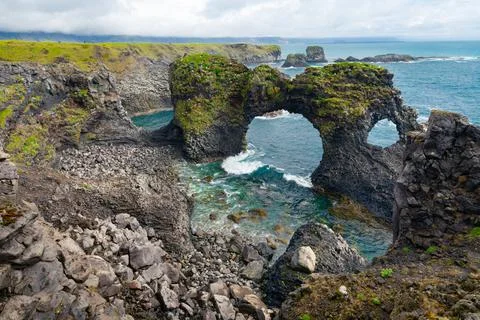 Rocks of Arnarstapi with nesting birds, Iceland, Snaefellsness. Black stone Stock Photos