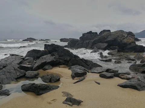 Rocks on the beach after the storm Stock Photos