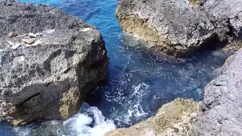 The rocks on the beach are hit by ocean waves Stock Footage 297035514