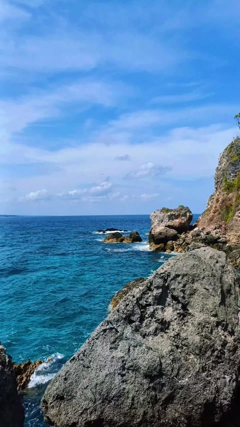 The rocks on the beach are hit by ocean waves Stock Footage 297035675