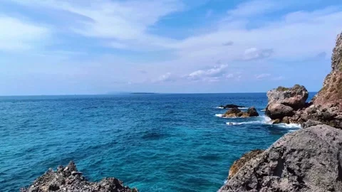 The rocks on the beach are hit by ocean waves Stock Footage 297060809