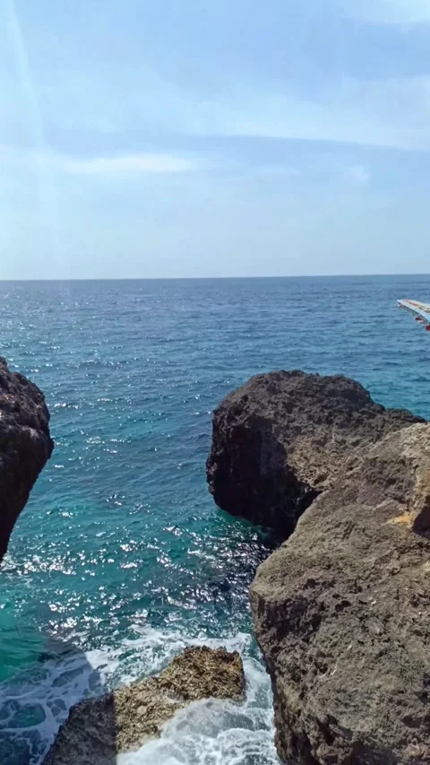 The rocks on the beach are hit by ocean waves Stock Footage 297136460