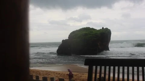 Rocks on the beach with big waves and drizzling rain. Stock Footage 253632122