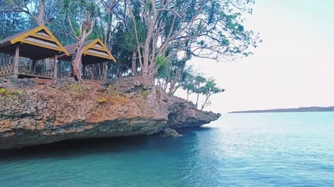 Rocks on the beach with calm waves Stock Footage 297133336
