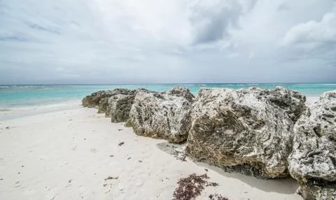Rocks on a beach in caribbean islands Stock Photos